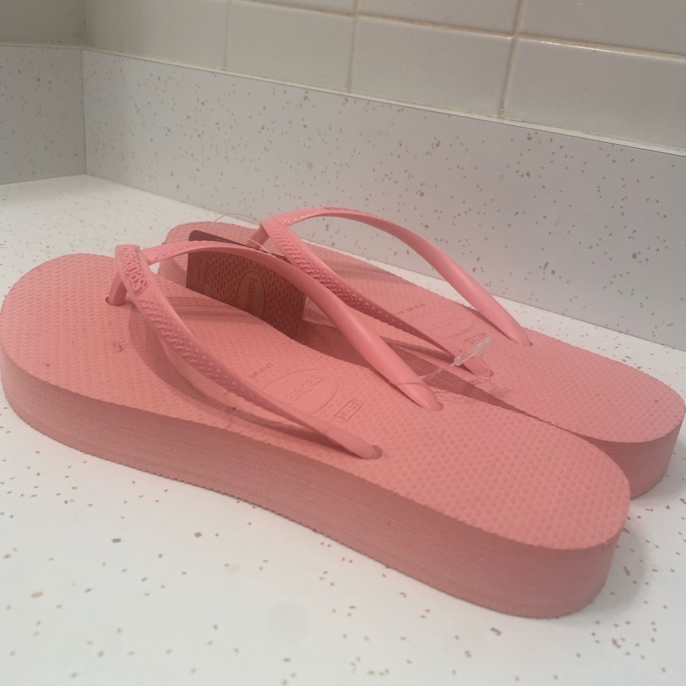Flamingo pink platform flip flops. Only $45. Please share.